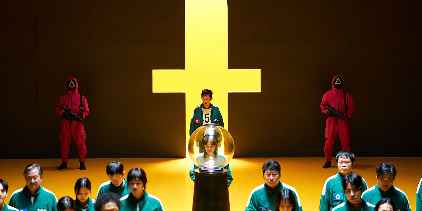 Seong Gi-hun (Lee Jung-jae) waiting in line to pick from a gumball machine in Squid Game Season 3.