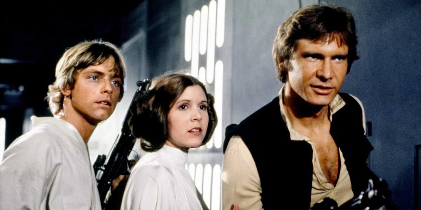 Luke, Leia, and Han Solo posing in a hallway in the original Star Wars