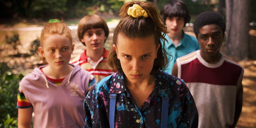 Eleven and the rest of the cast stand and look determined towards the camera in Stranger Things.