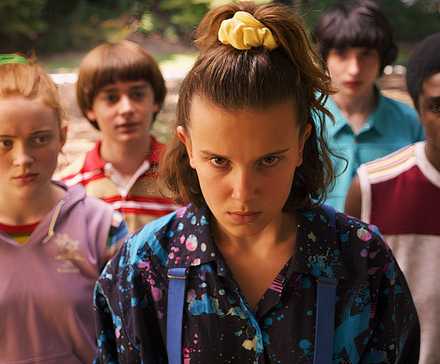 Eleven and the rest of the cast stand and look determined towards the camera in Stranger Things.