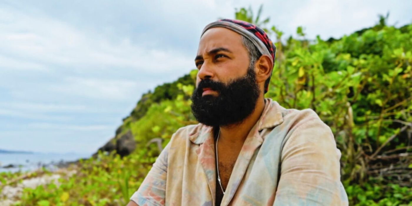 Yam Yam stares out into the distance with the ocean behind him on 'Survivor 44.'