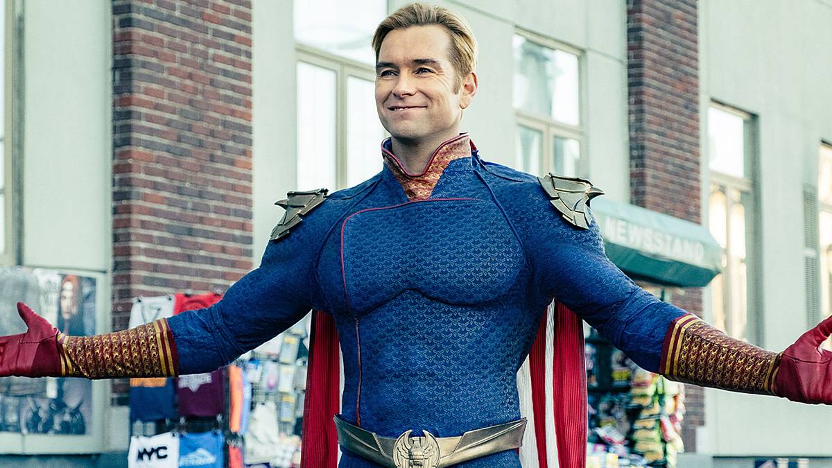 Antony Starr as John Homelander in his supersuit with arms open and a wide smile in The Boys.
