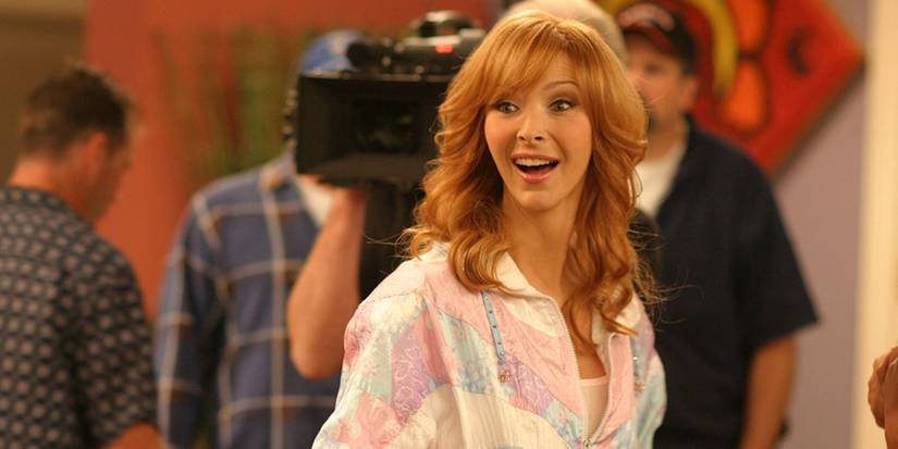 Lisa Kudrow looking pleased and surprised with a cameraman behind her in The Comeback.