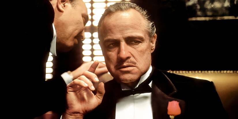 Marlon Brando as Don Vito Corleone getting a message from someone in The Godfather