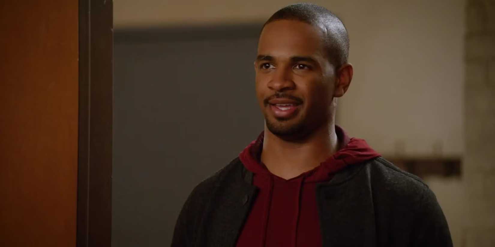Daman Wayans Jr. as Coach standing in a doorway in the pilot episode of 'New Girl.'