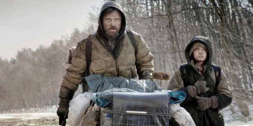 Viggo Mortensen as Man and Kodi Smit-McPhee as Boy walk down an abandoned highway in The Road.