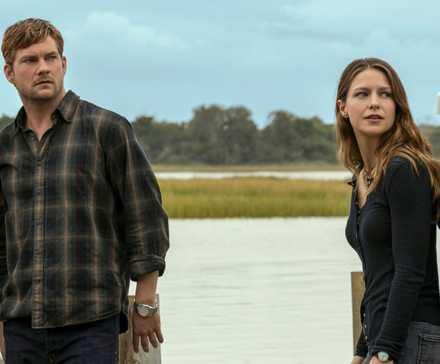 Jake Weary as Cane standing outside on the dock with Melissa Benoist as Bree in The Waterfront