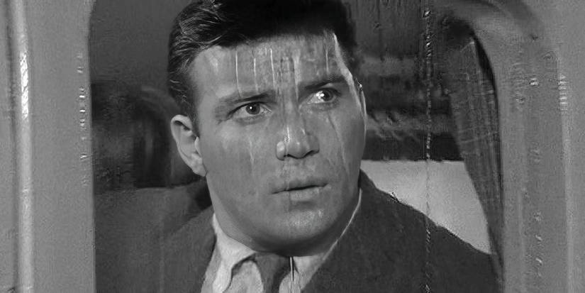 William Shatner looks concerned out a rainy airplane window in Twilight Zone's Nightmare at 20,000 Feet.