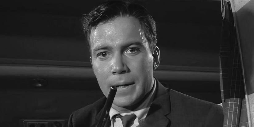 William Shatner as Robert Wilson in a nervous sweat with a gun in Twilight Zone's Nightmare at 20,000 Feet.