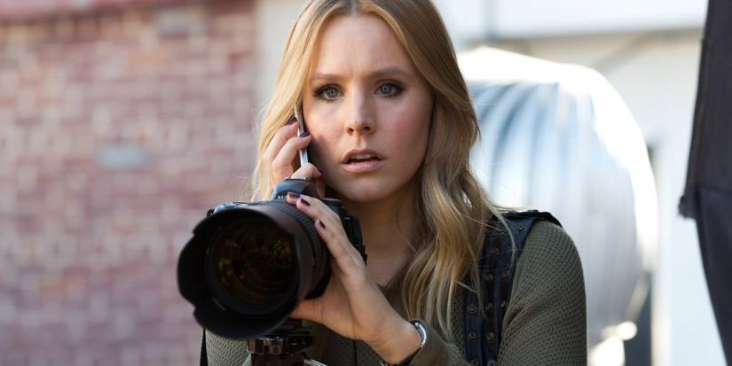 Kristen Bell's Veronica Mars looking shocked with a camera in the Veronica Mars revival.