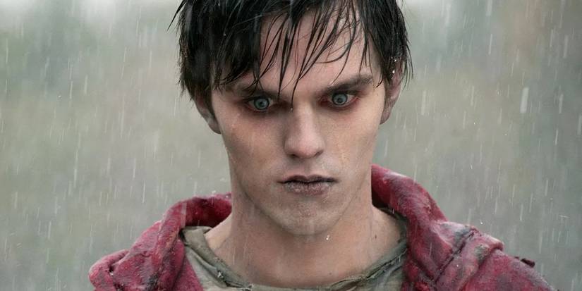Actor Nicholas Hoult as the zombie R, standing in the rain with wide, pale eyes in Warm Bodies.