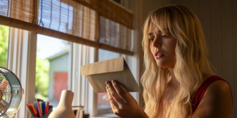 Emily Alyn Lind as Cadence Sinclair looking at an envelope in 'We Were Liars'.