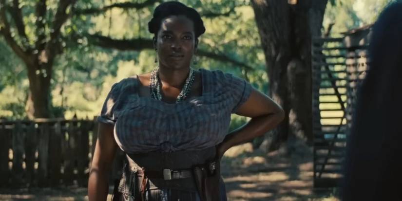 Wunmi Mosaku as Annie in Sinners looking at the camera with her hand on her hip