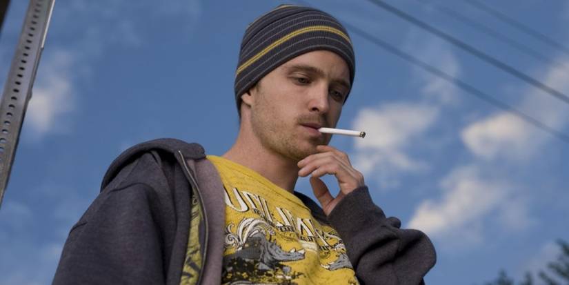 Aaron Paul smoking a cigarette and looking down in the Peekaboo episode of Breaking Bad.