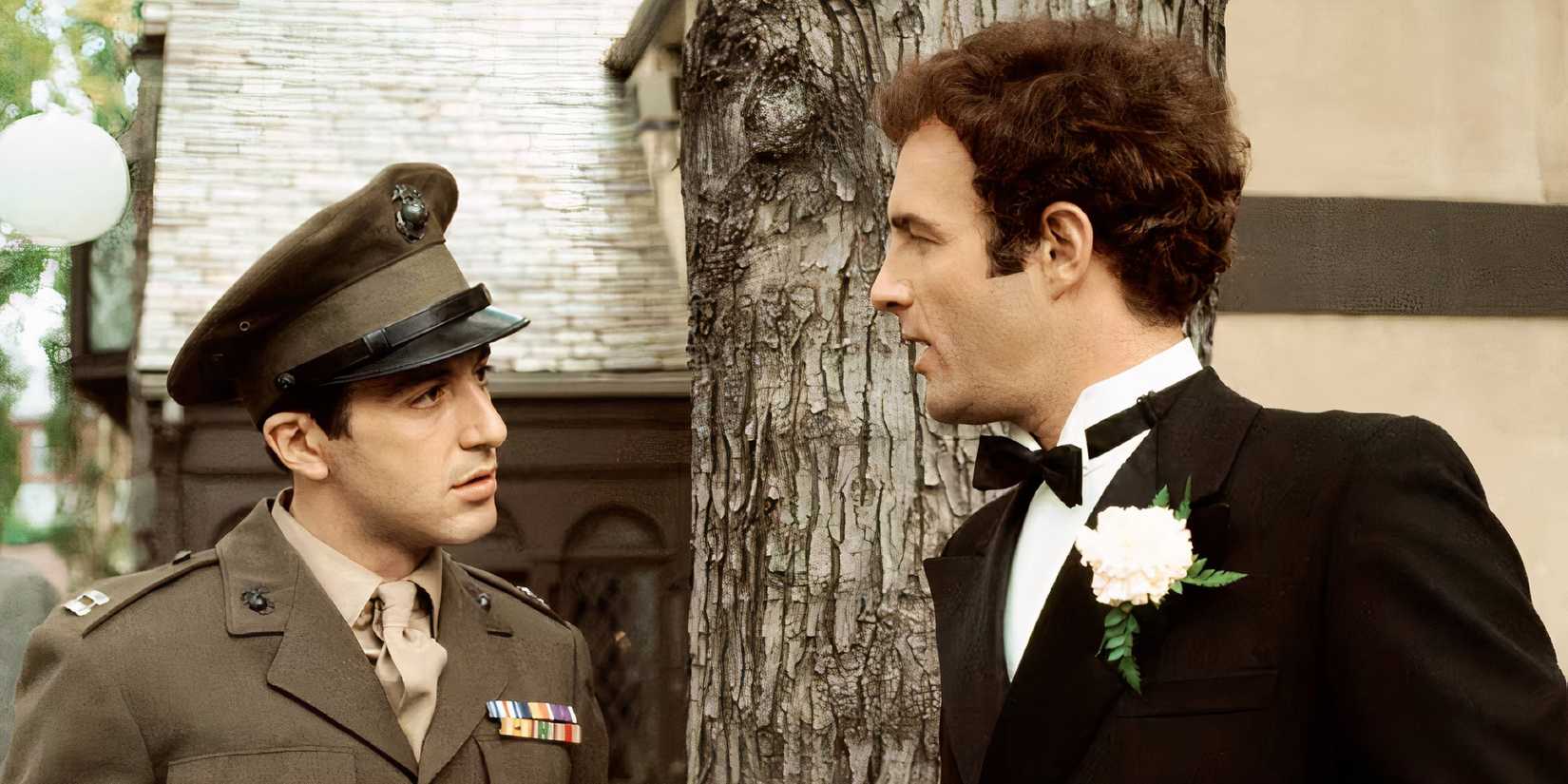 Al Pacino and James Caan as Michael and Sonny Corleone talking beside a tree in The Godfather