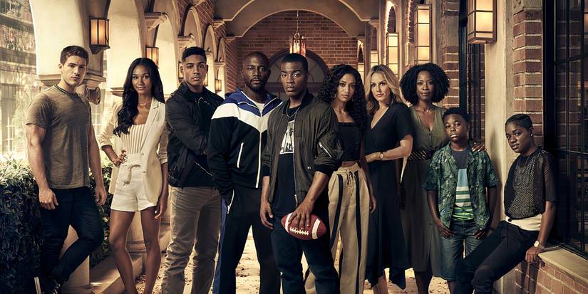 All American's cast of characters posing in a brick corridor and looking at the camera. 