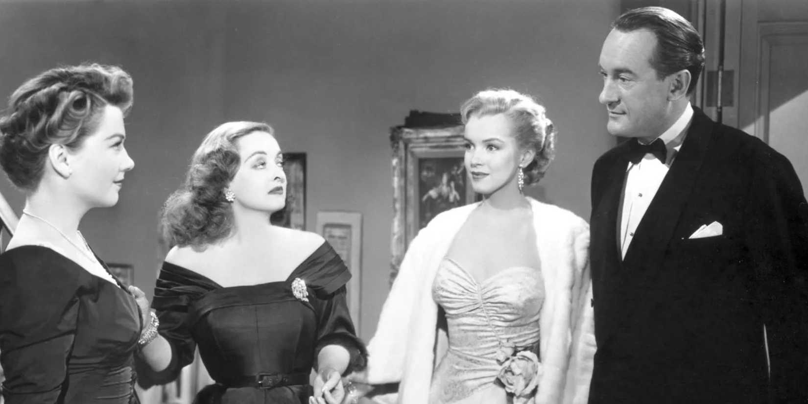 Anne Baxter, Bette Davis, Marilyn Monroe and George Sanders standing next to each other in All About Eve (1950)