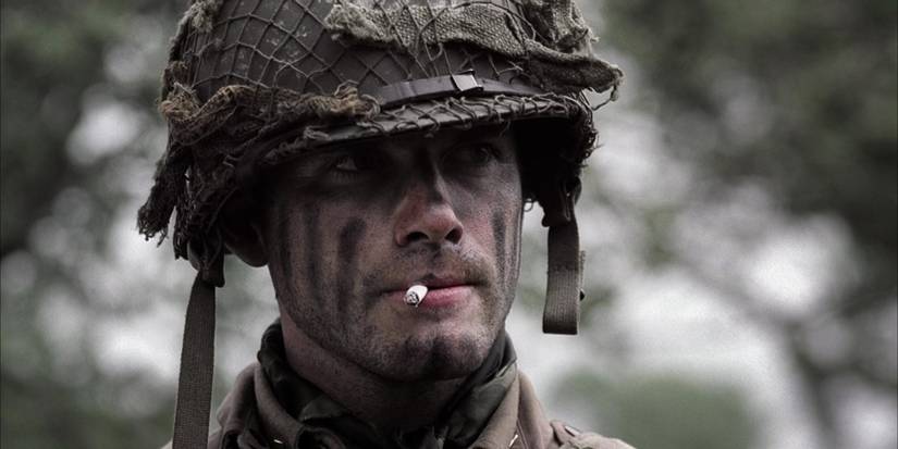 Matthew Settle with a cigarette in his mouth looking at someone off-screen to the right in Band of Brothers, Day of Days