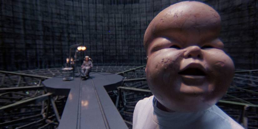 A man with a baby mask near the end of Terry Gilliam's Brazil (1985)