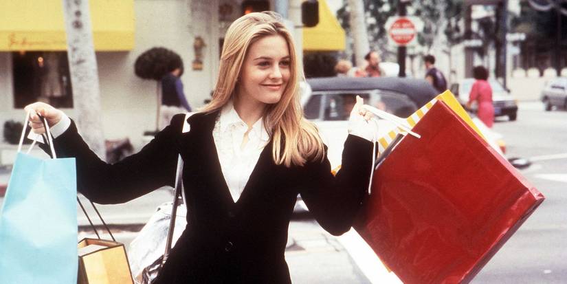 Alicia Silverstone as Cher Horowitz holding shopping bags in Clueless