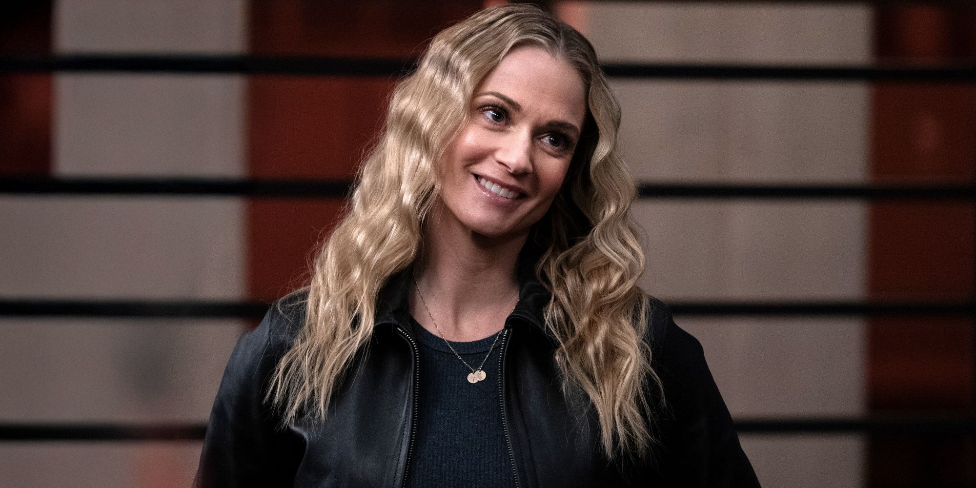 A.J. Cook as JJ smiling in a black shirt and black jacket in Criminal Minds: Evolution Season 18