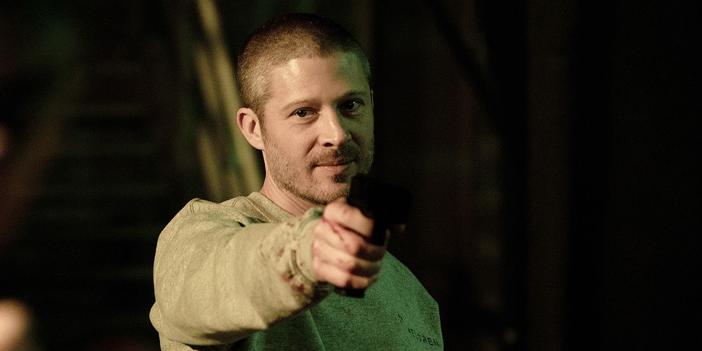 Voit (Zach Gilford) holding up a gun in Criminal Minds: Evolution Season 3