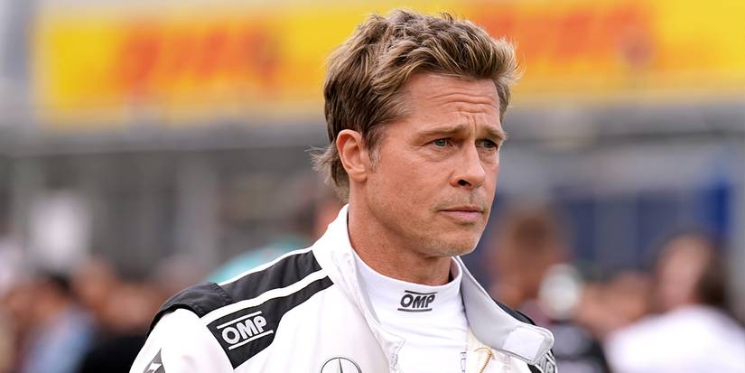 Brad Pitt as Sonny Hayes watches the racetrack seriously in F1: The Movie.