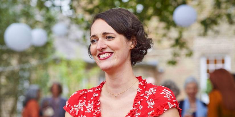 Phoebe Waller-Bridge smiling in a red dress outdoors in Fleabag.