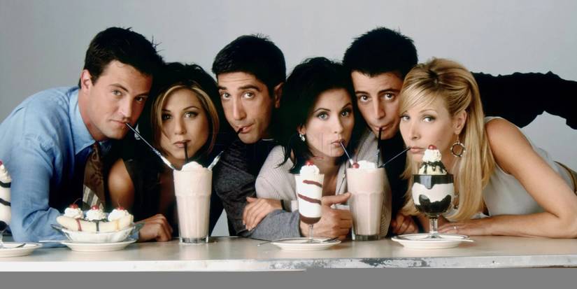 The cast of Friends drinking from straws in milkshakes while looking at the camera in a promo photo.