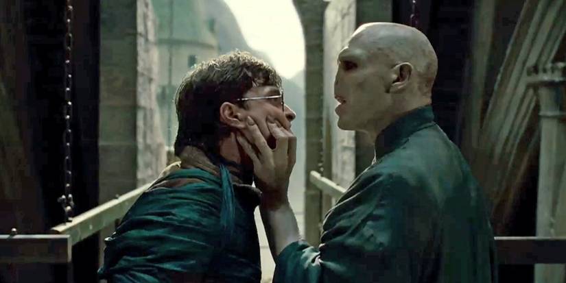Voldemort holds Harry by the face and stares at him in the Harry Potter film series.