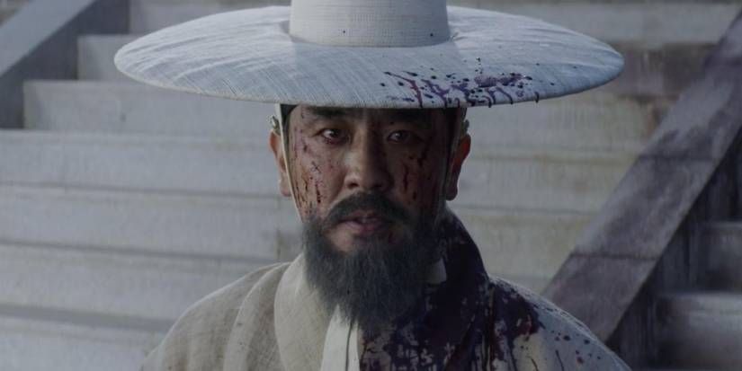 Ryu Seung-ryong in Kingdom wearing a hat and looking ahead seriously. 