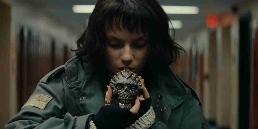 Dafne Keen as Chrys blows into an ancient Aztec death whistle in her high school hallway in Whistle