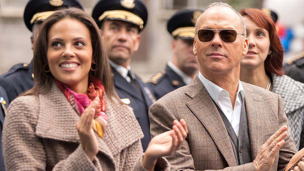 Michael Keaton claps among a crowd in Robocop remake