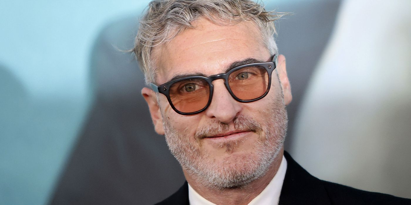 Joaquin Phoenix on the red carpet wearing glasses