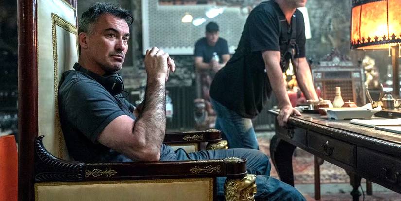 Chad Stahelski sits in a chair on the set of John Wick 3