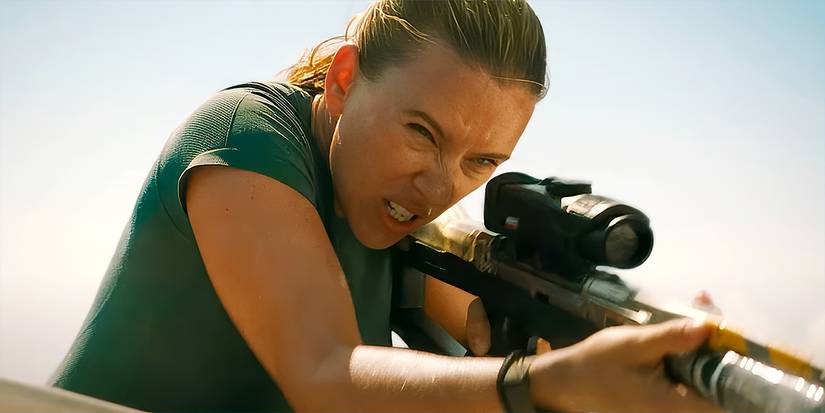 Zora (Scarlett Johansson) uses a special gun to extract dinosaur DNA in Jurassic World Rebirth.