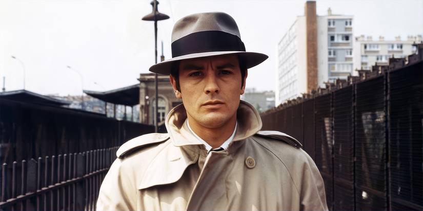 Alain Delon as Jef Costello walking down the street in Le Samourai