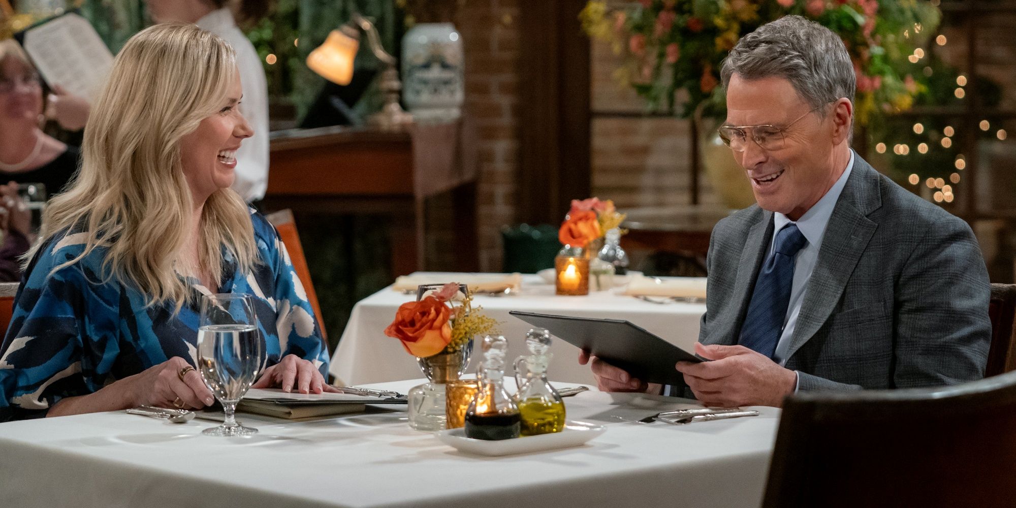 Leanne Morgan as Leanne sitting at a table at dinner with Tim Daly as Andrew in the Netflix sitcom Leanne