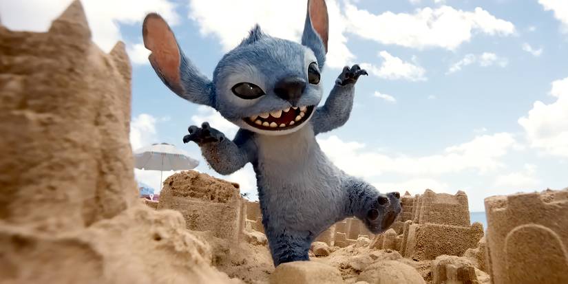 Stitch (Chris Sanders) crashes through sand castles like Godzilla in Lilo and Stitch (2025).