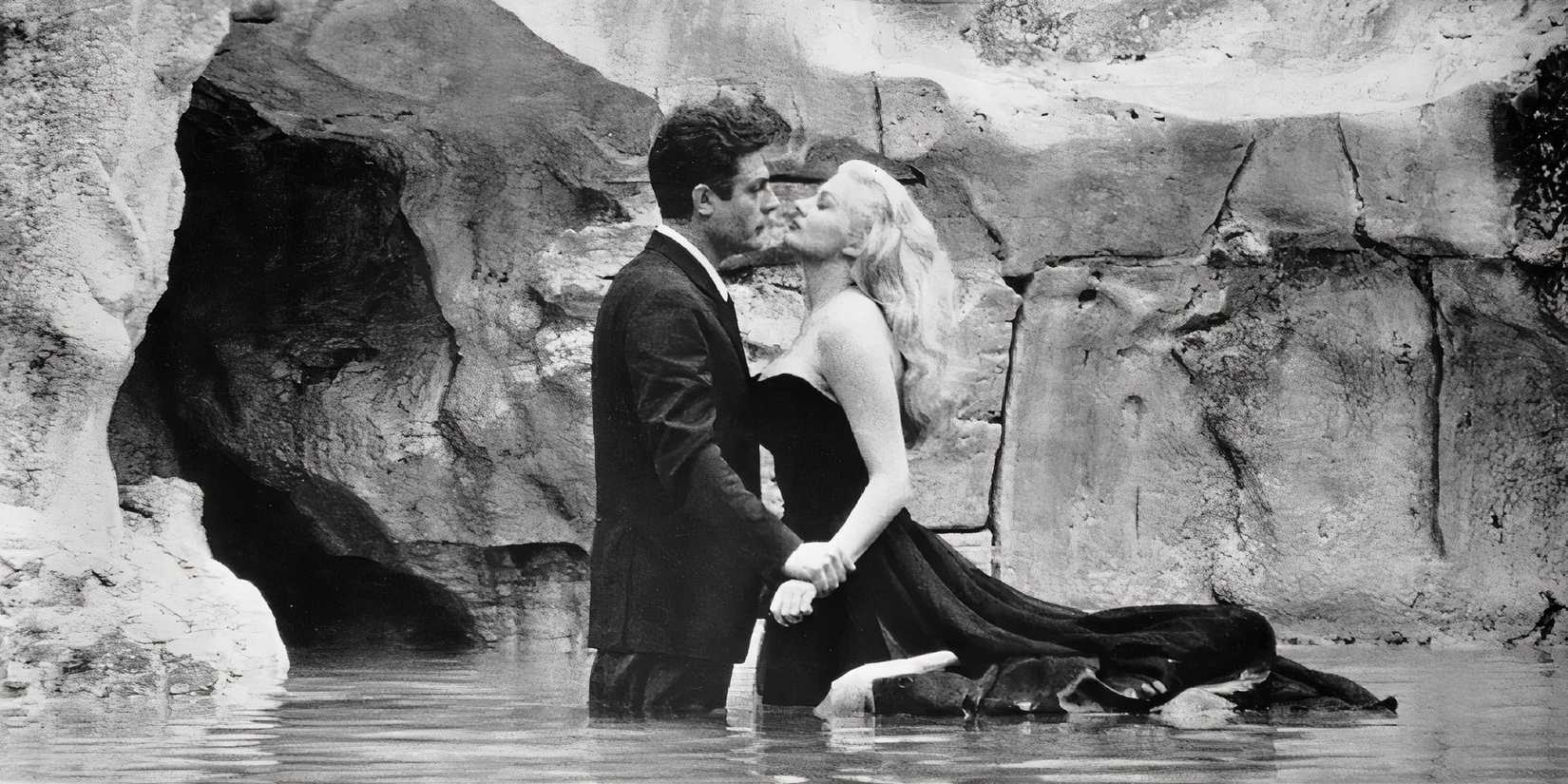 Marcello Mastroianni and Anita Ekberg in La Dolce Vita inside a fountain.