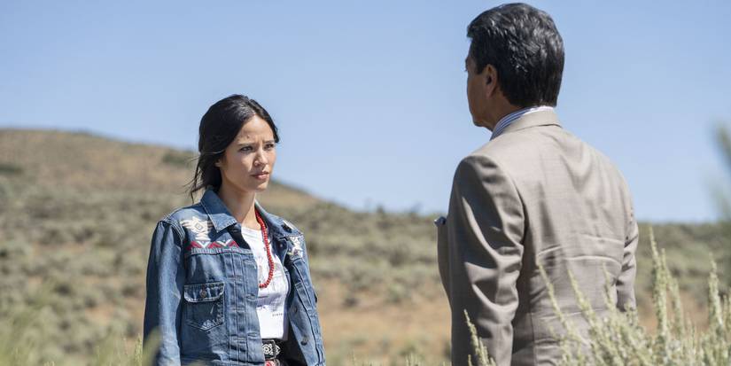 Monica and Thomas Rainwater talking in a field in Yellowstone, All for Nothing.