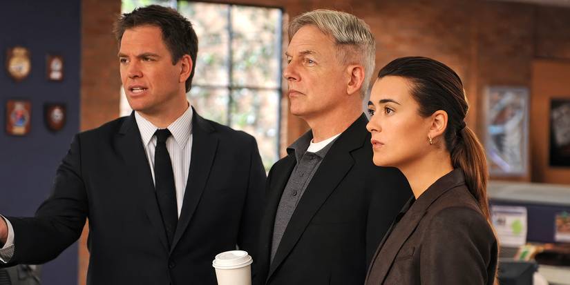 Michael Weatherly, Cote de Pablo, and Mark Harmon stare at something off-screen in NCIS.