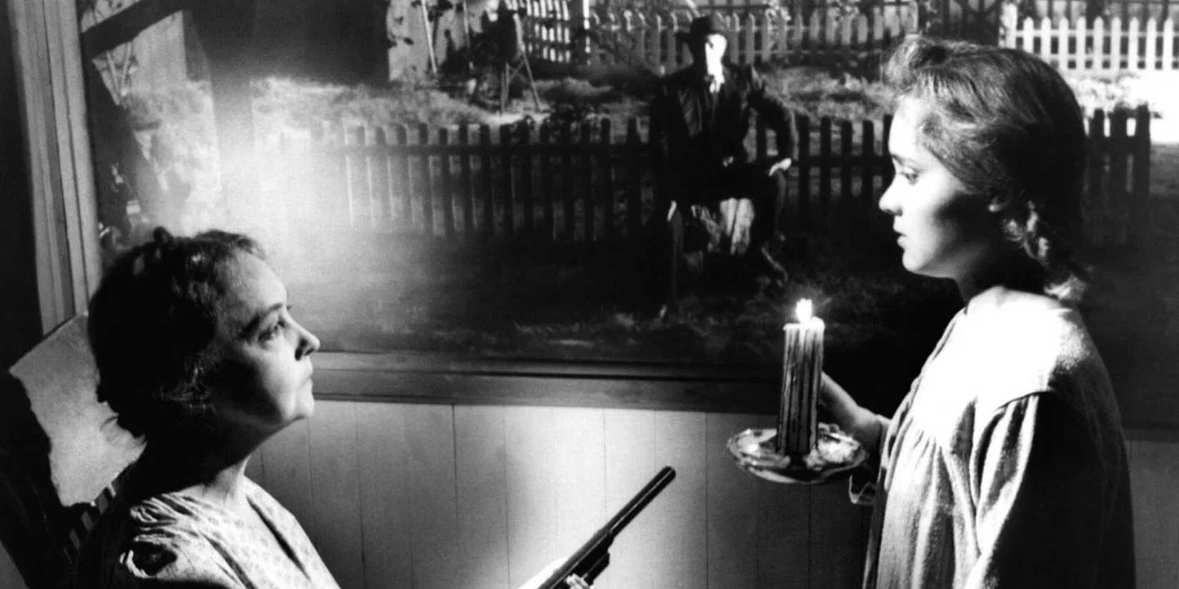 A woman facing a girl while a man watches in the backfround in Night of the Hunter