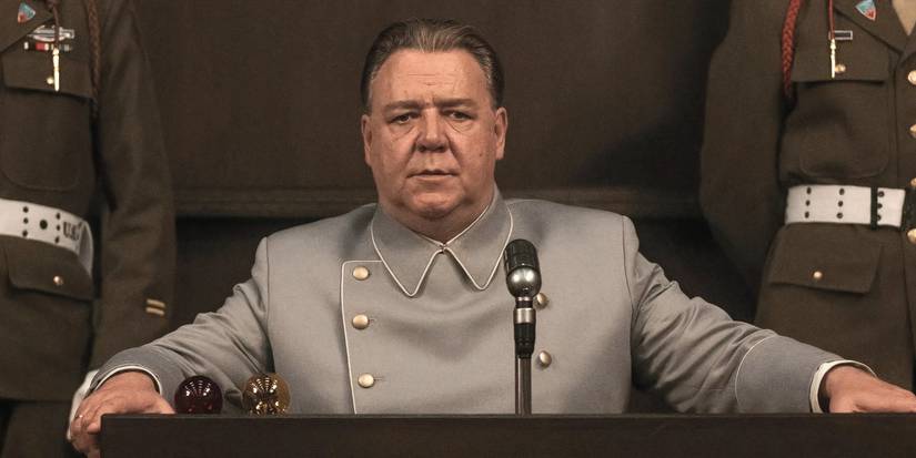 Russell Crowe taking the stand with two soldiers beside him in Nuremberg