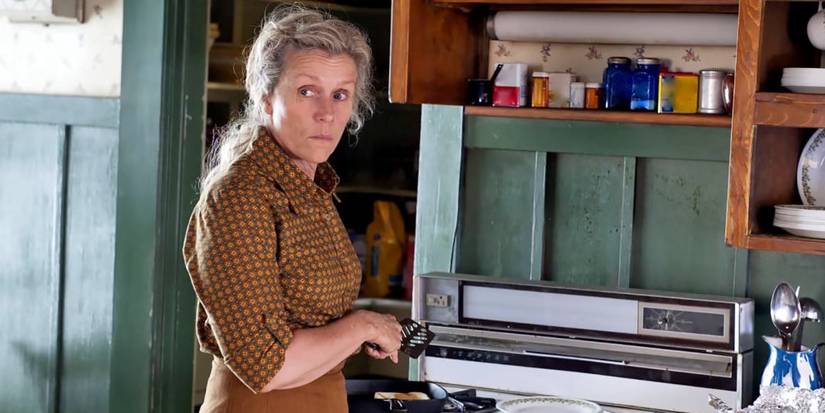 Frances McDormand as Olive cooking while looking back at something in Olive Kitteridge.
