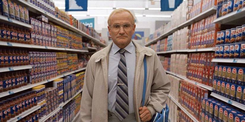 Sy Parrish, standing in a grocery store aisle and staring blankly into the camera in One Hour Photo