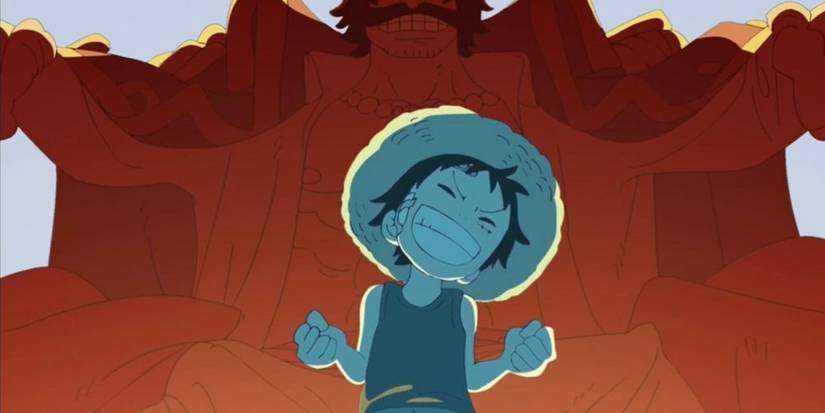 Young Luffy standing in front of Gol. D Roger in One Piece.