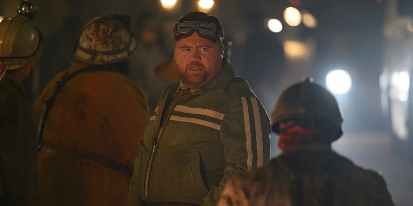 Paul Walter dressed as Mole Man in The Fantastic Four: First Steps inside a cave with two other figures.