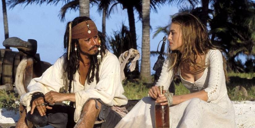 Johnny Depp and Keira Knightley sit on an island in Pirates of the Caribbean: The Curse of the Black Pearl 