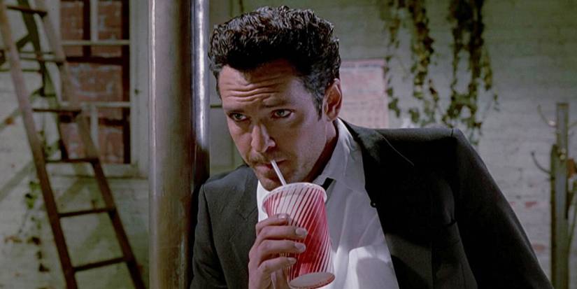 Michael Madsen as Mr. Blonde sipping a drink in Reservoir Dogs (1992)